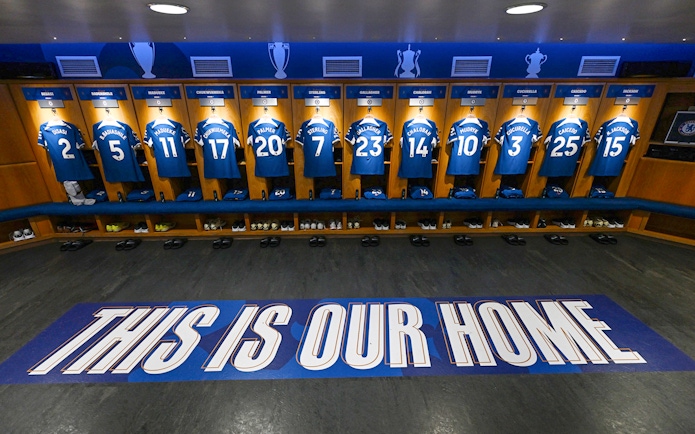 Chelsea FC locker room with player jerseys displayed during stadium tour.