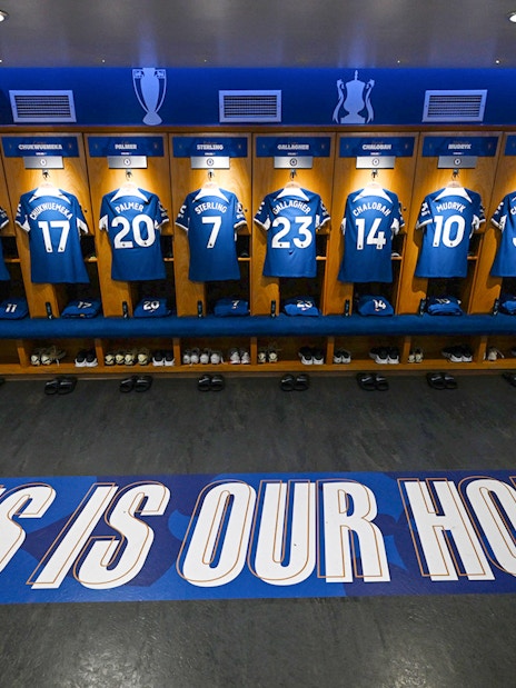 Chelsea FC locker room with player jerseys displayed during stadium tour.
