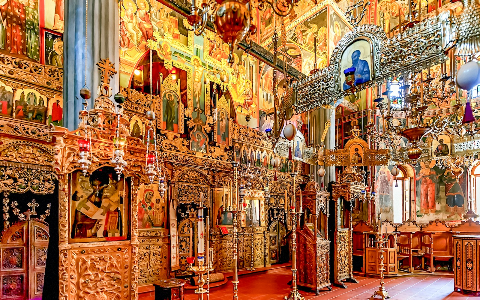 Interior of The Monastery of Great Meteoron with ornate religious icons and wooden carvings.