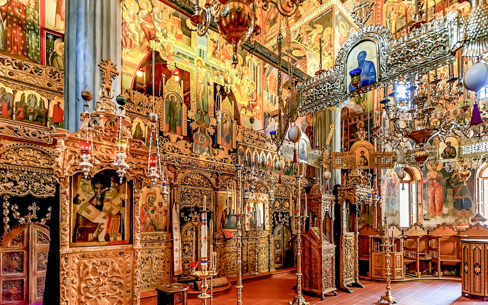 Interior of The Monastery of Great Meteoron with ornate religious icons and wooden carvings.