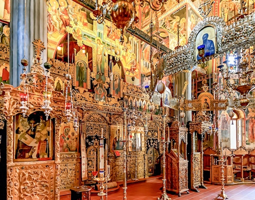 Interior view of The Monastery of Great Meteoron, showcasing ancient frescoes and stone architecture in Greece.