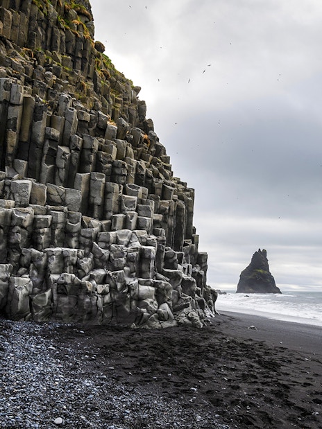 Basalt columns and sea stacks at Reynisfjara beach, Iceland.