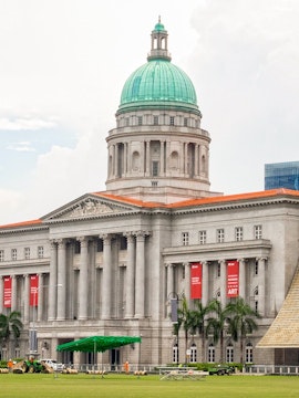 National Gallery Singapore exterior with dome and red banners.