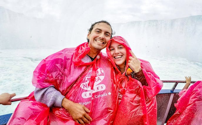 Tourists in red ponchos on a boat near Niagara Falls, Canada.