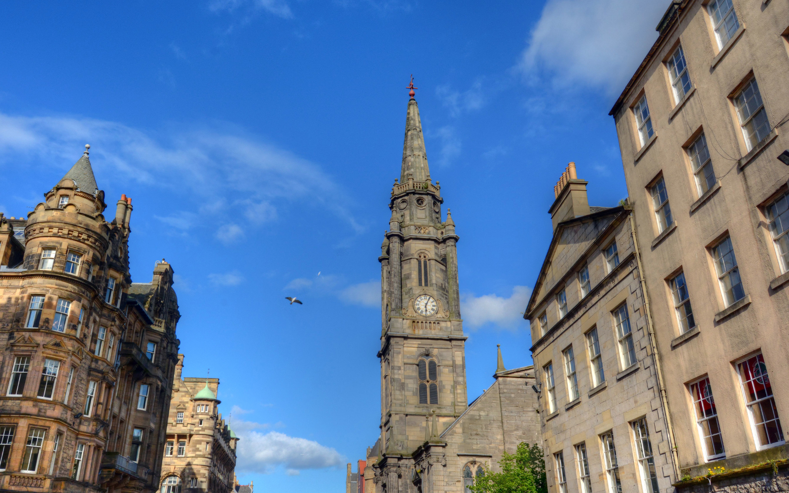 Historic street view of The Royal Mile in Edinburgh, Scotland, featuring cobblestone paths and historic architecture.