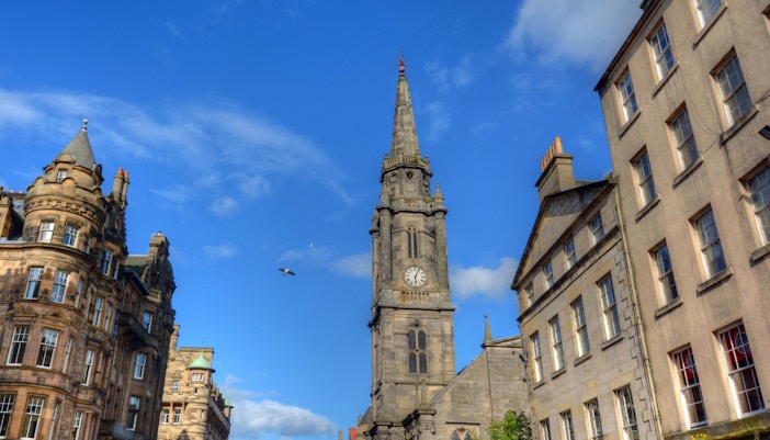 Historic street view of The Royal Mile in Edinburgh, Scotland, featuring cobblestone paths and historic architecture.