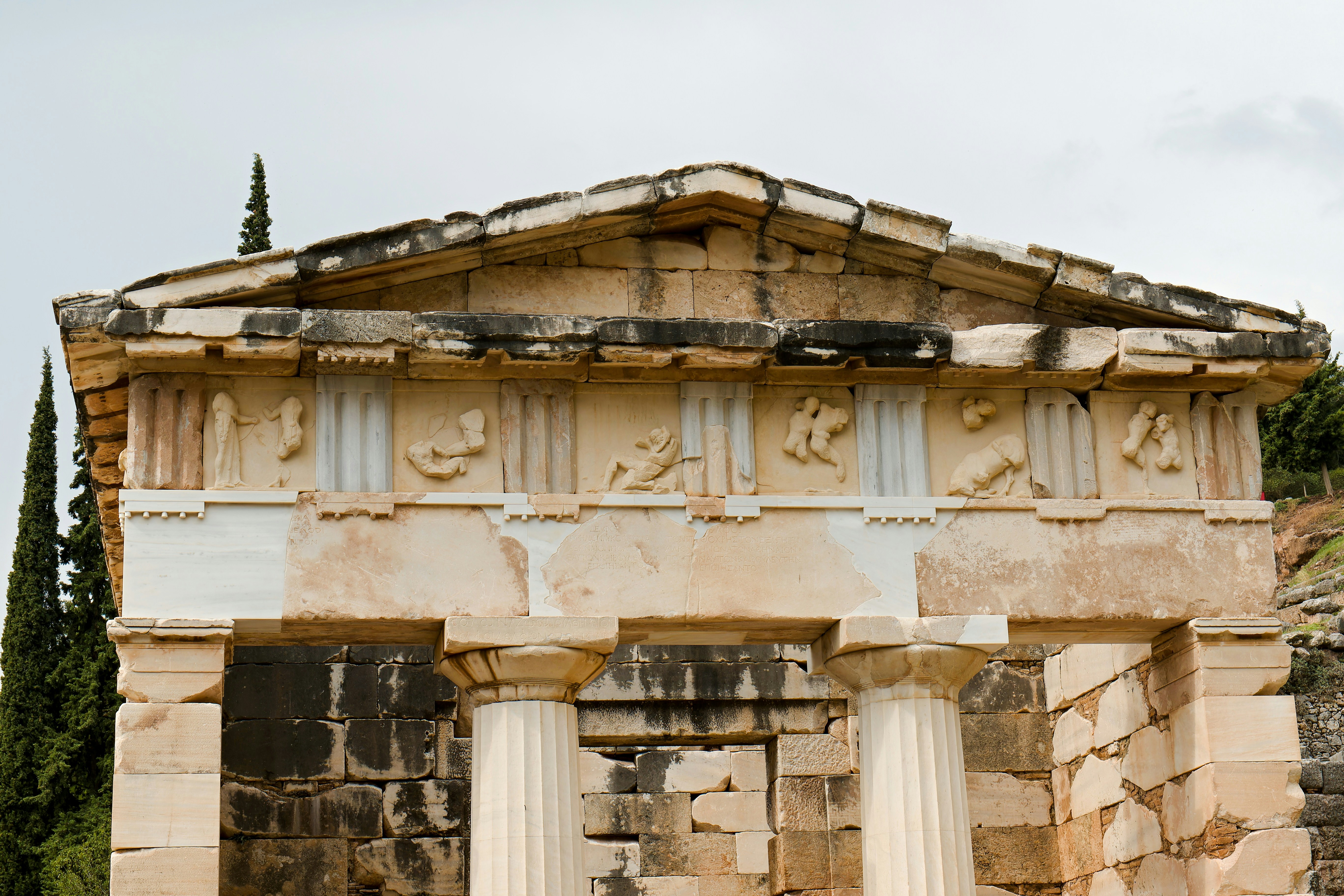 Athenian Treasury at Delphi with detailed friezes and Doric columns.