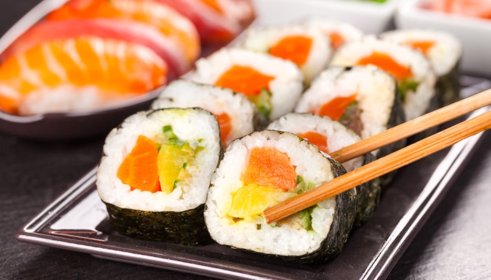 Sushi pieces with chopsticks in Tokyo, Japan.