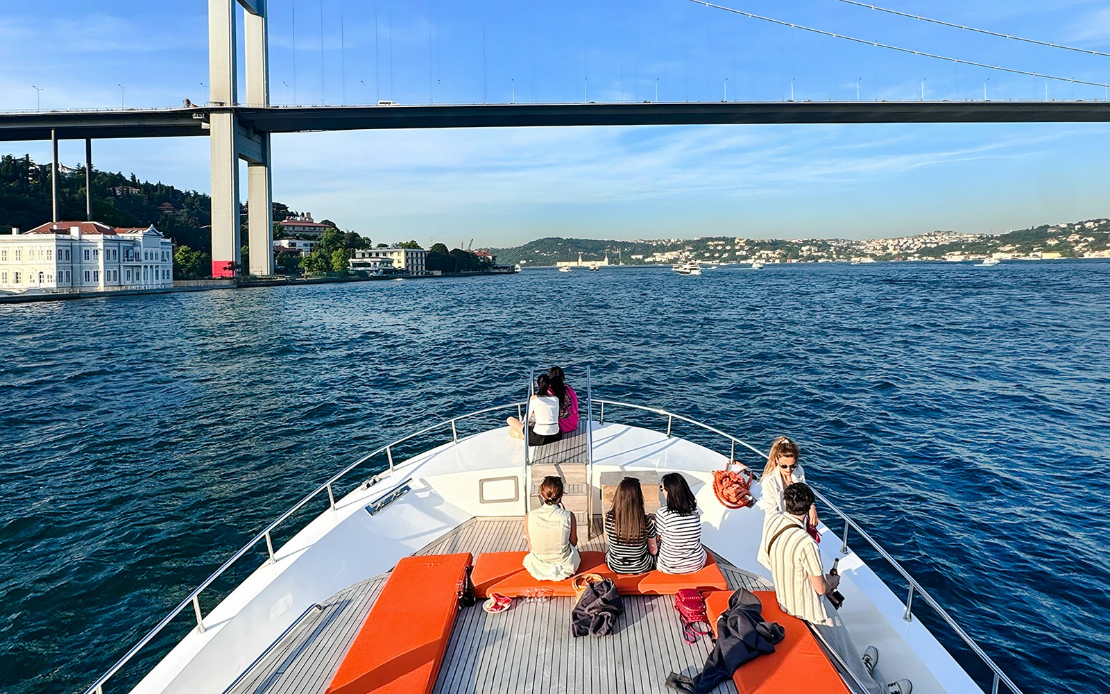 Passengers on yacht viewing Bosphorus Bridge, Istanbul.