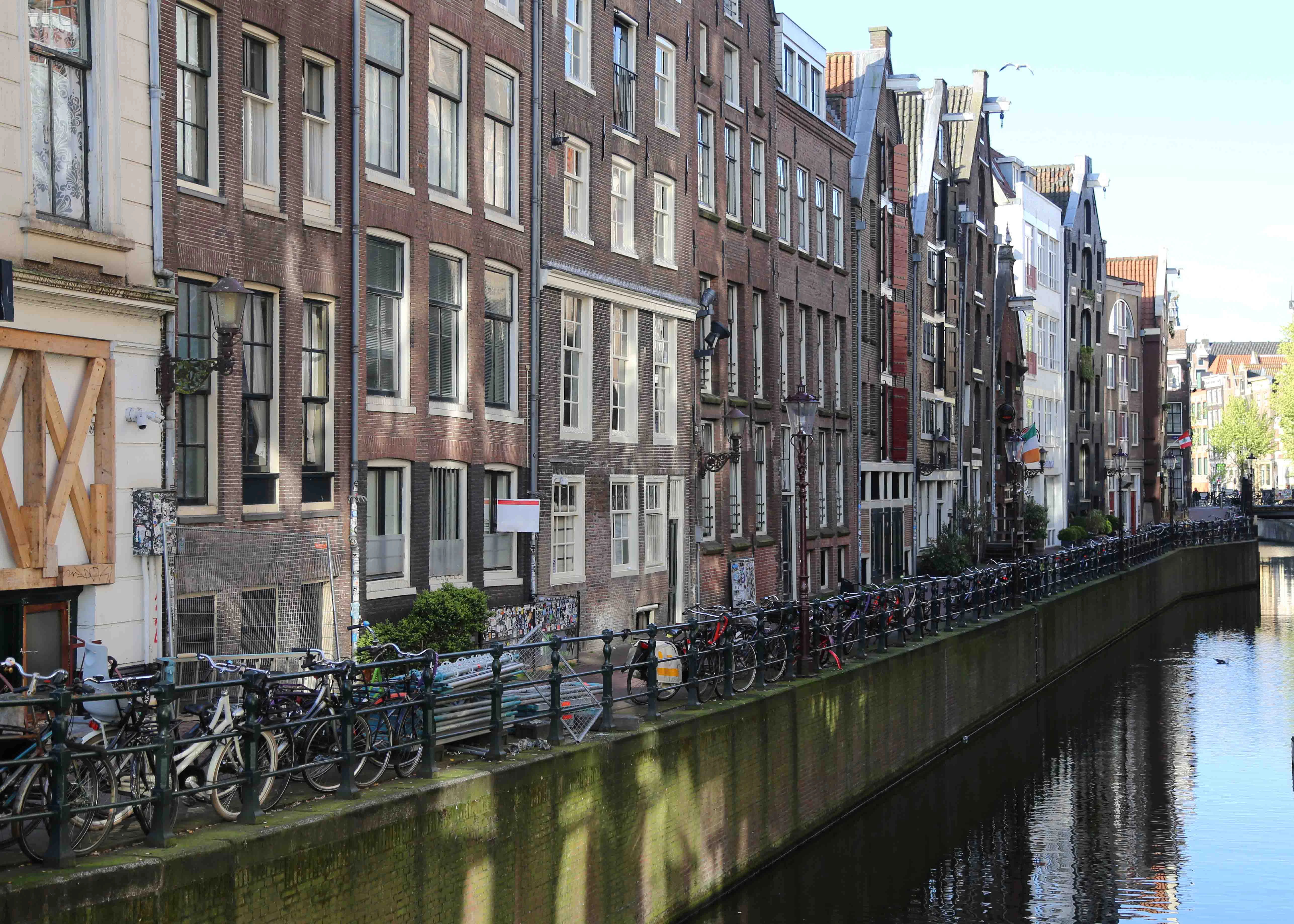 Canal-side buildings and bicycles in Amsterdam, Netherlands.