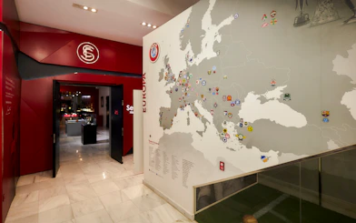 Sevilla FC museum entrance with European football club map display.