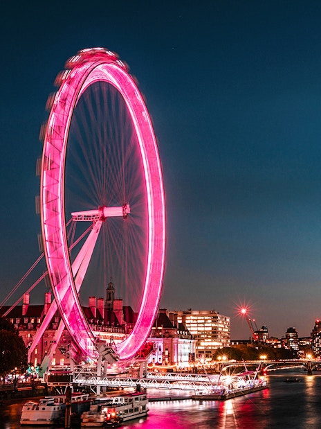 London Eye illuminated at night, view from the Thames, London Eye Champagne Experience.