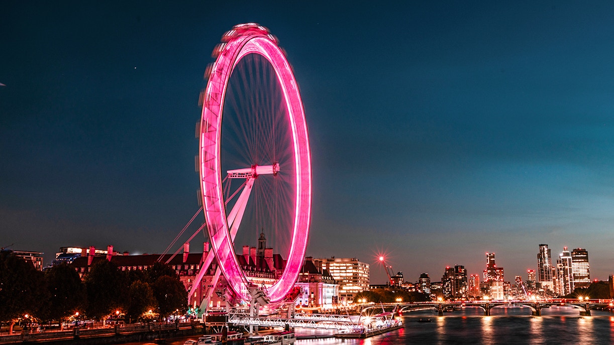 London Eye illuminated at night, view from the Thames, London Eye Champagne Experience.
