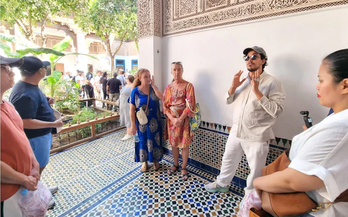 Tour group listening to a guide at Bahia Palace, Marrakech.