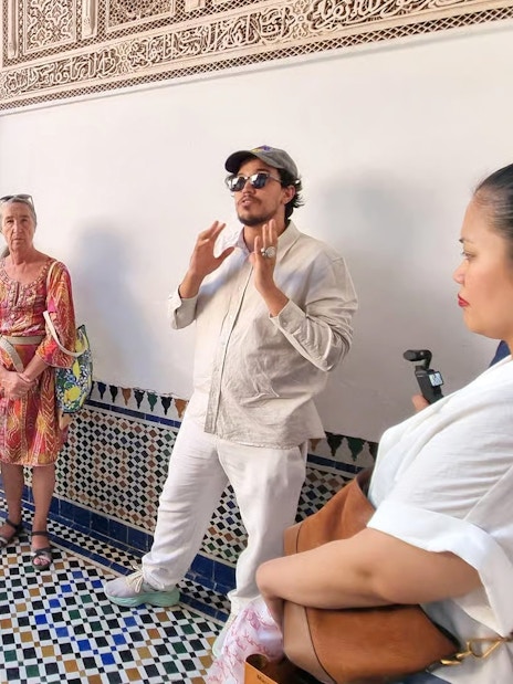 Tour group listening to a guide at Bahia Palace, Marrakech.