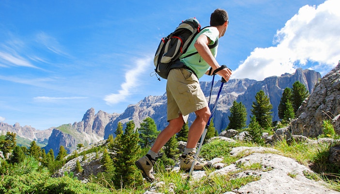 Hikers on Marmot Nature Trail with alpine views in Grindelwald First, Switzerland.