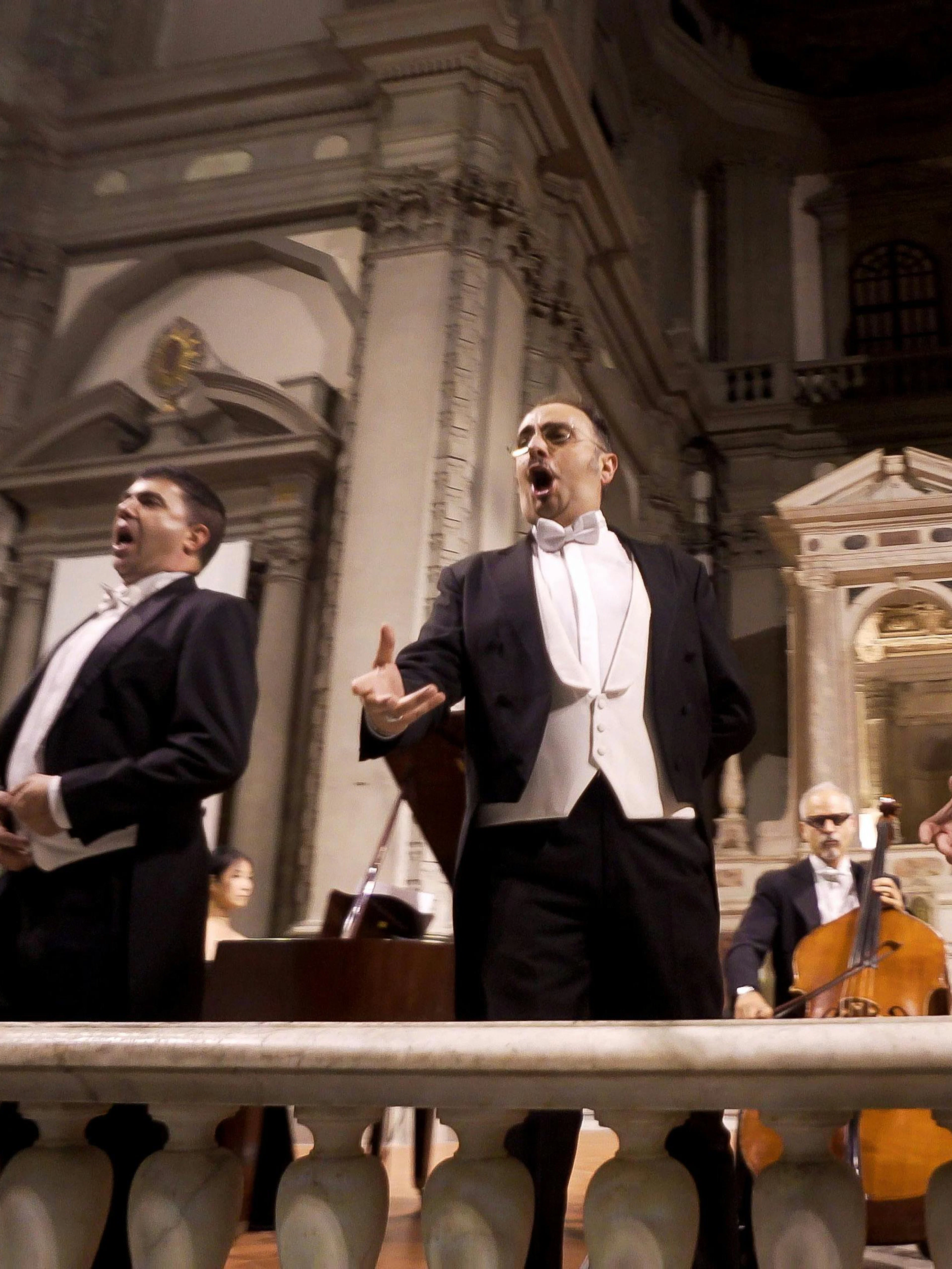 Three tenors performing in a historic Florence venue during a Tuscan dinner concert.