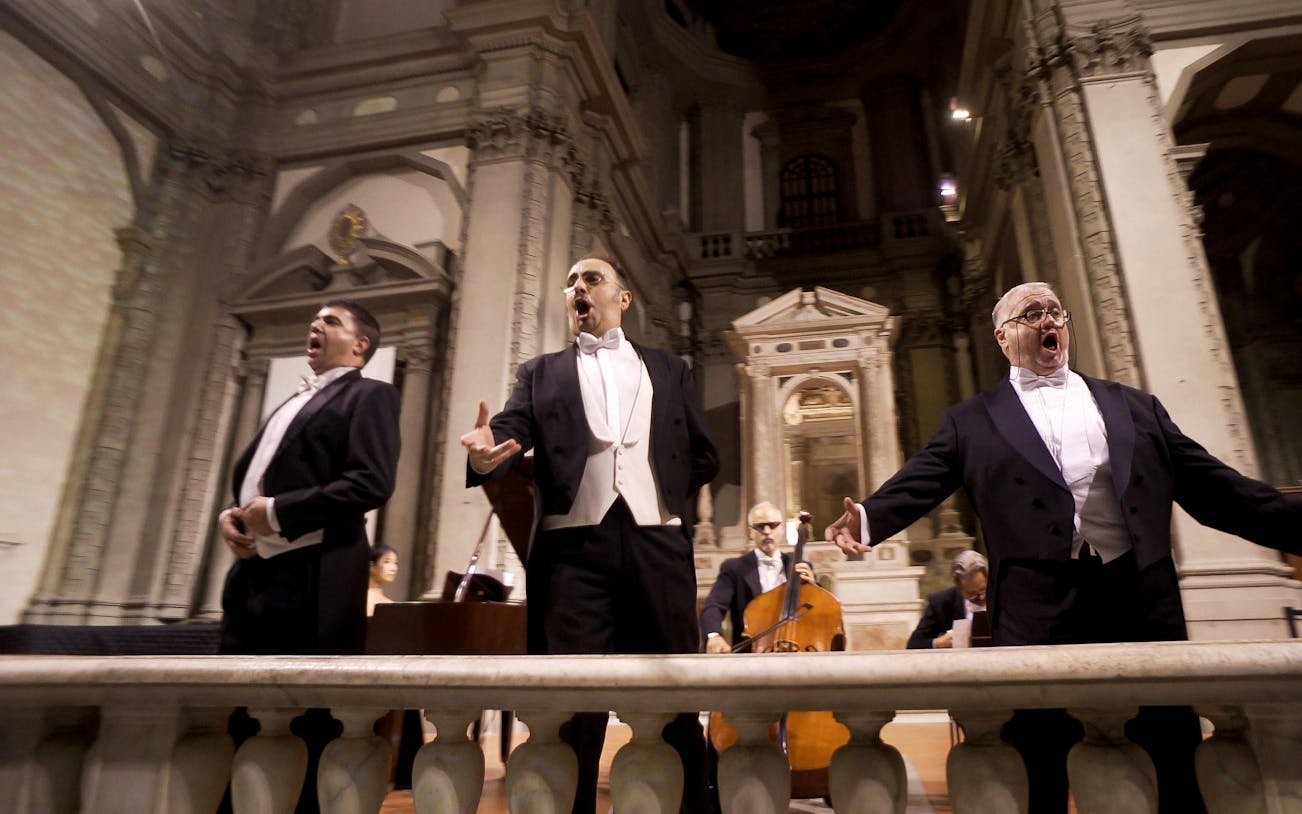 Three tenors performing in a historic Florence venue during a Tuscan dinner concert.