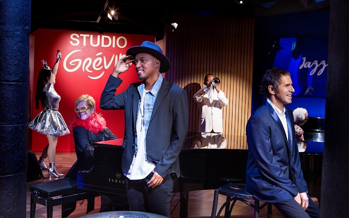 Wax figures of musicians and performers at Grévin Paris Wax Museum.