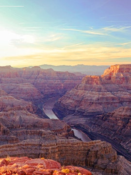 Grand Canyon view with Colorado River winding through rocky cliffs, Arizona.