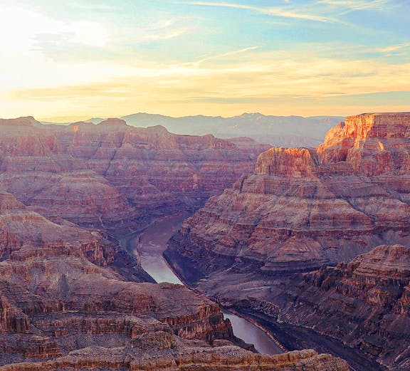 Grand Canyon view with Colorado River winding through rocky cliffs, Arizona.