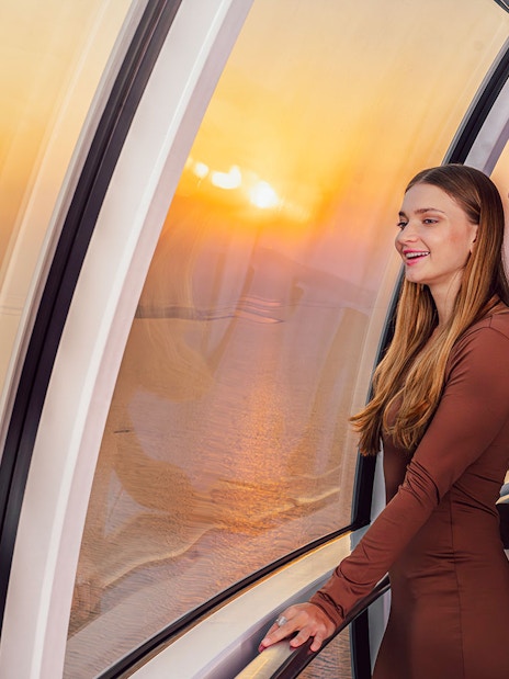 Visitors enjoying sunset views inside Ain Dubai observation wheel.