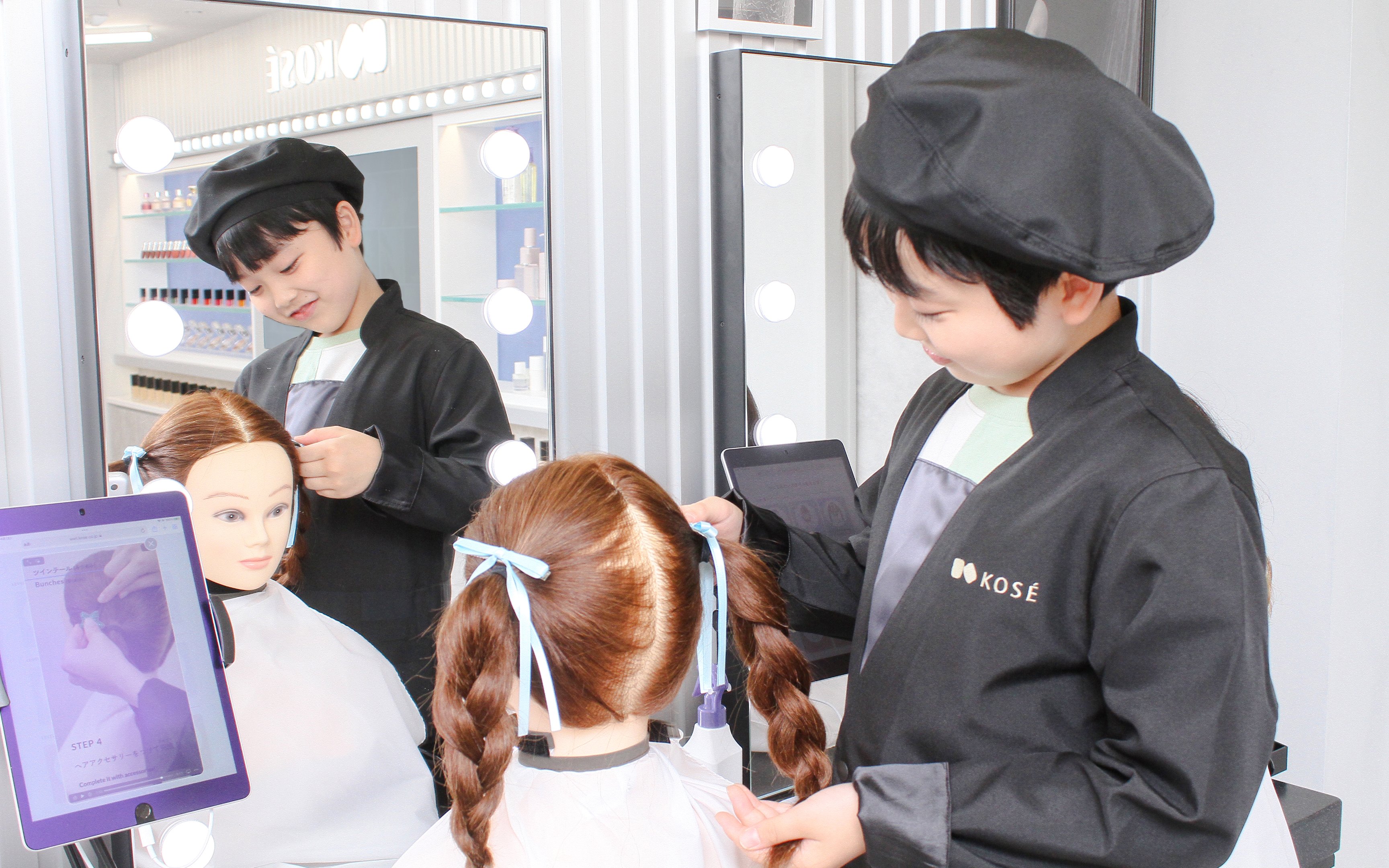 Child styling mannequin hair at KidZania Tokyo salon.