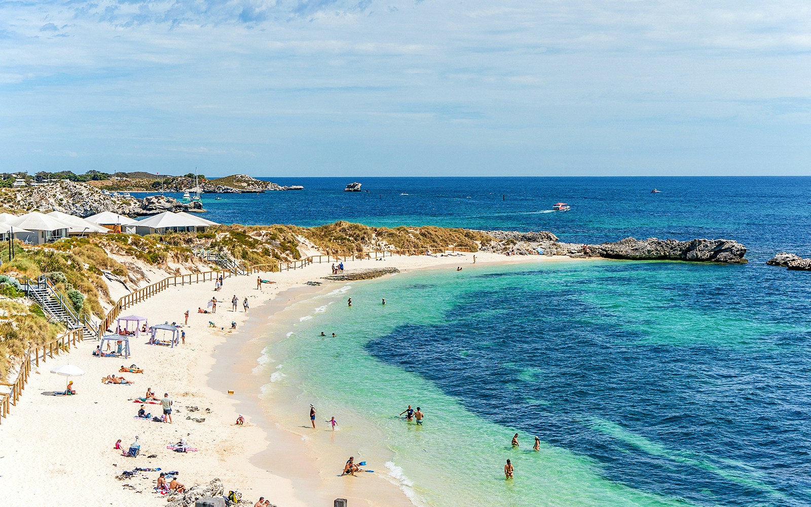 Ferry approaching Rottnest Island with clear blue waters and distant coastline.