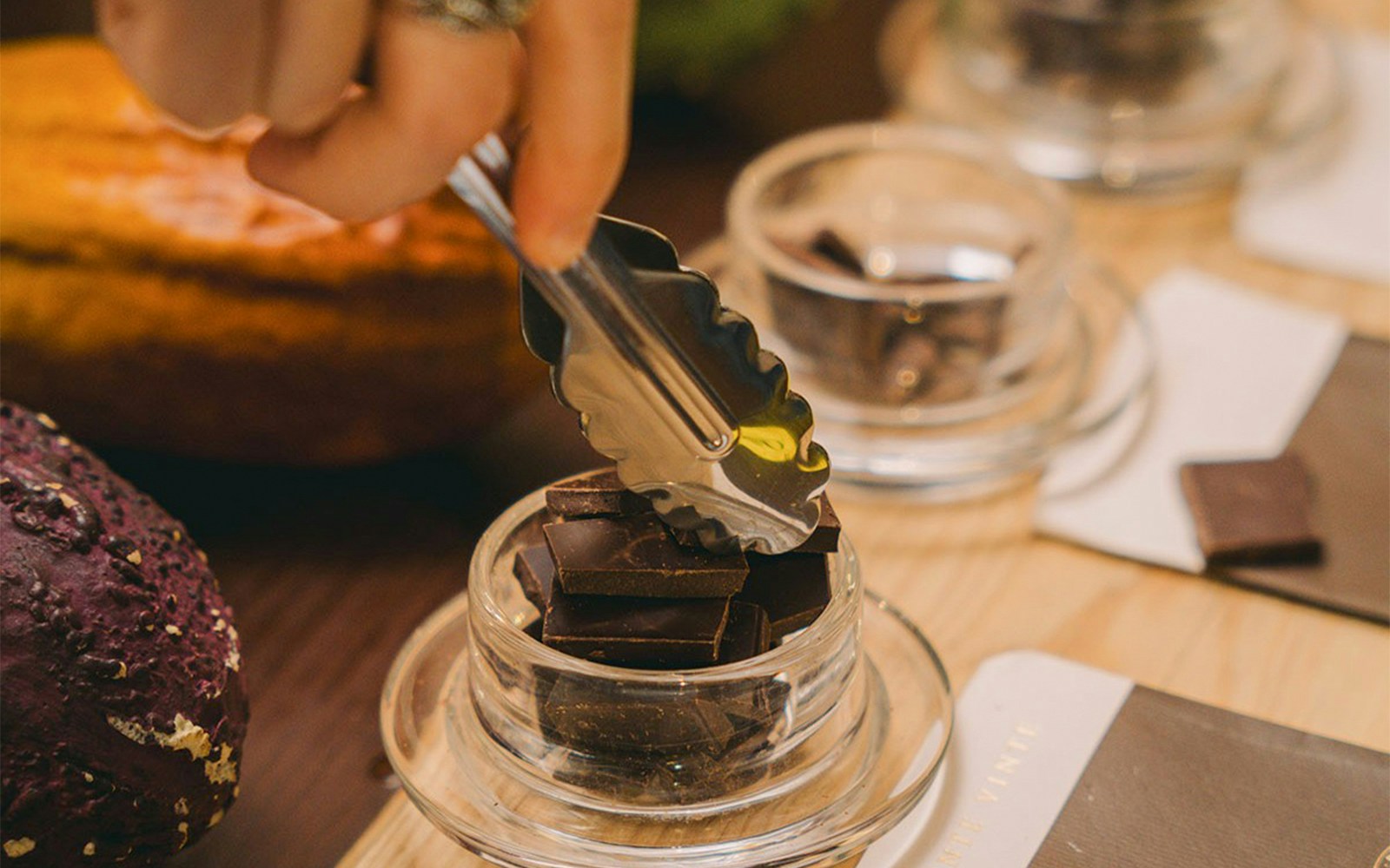 Chocolate slices being picked with tongs at Chocolate Story Museum Porto.