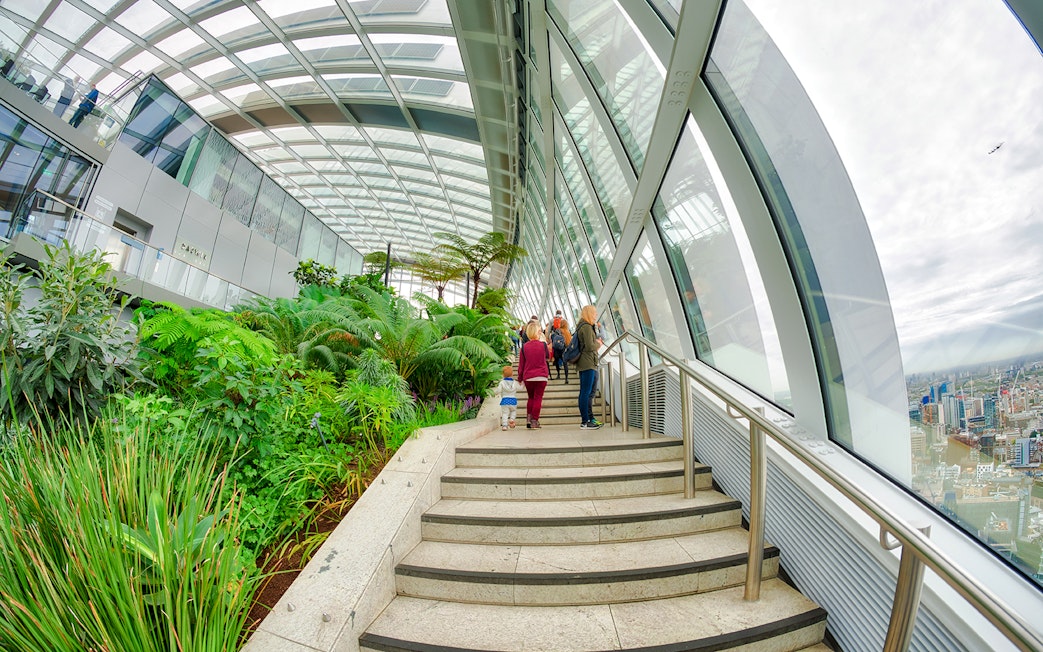Visitors walking through lush greenery at The Sky Garden, 20 Fenchurch Street, London.