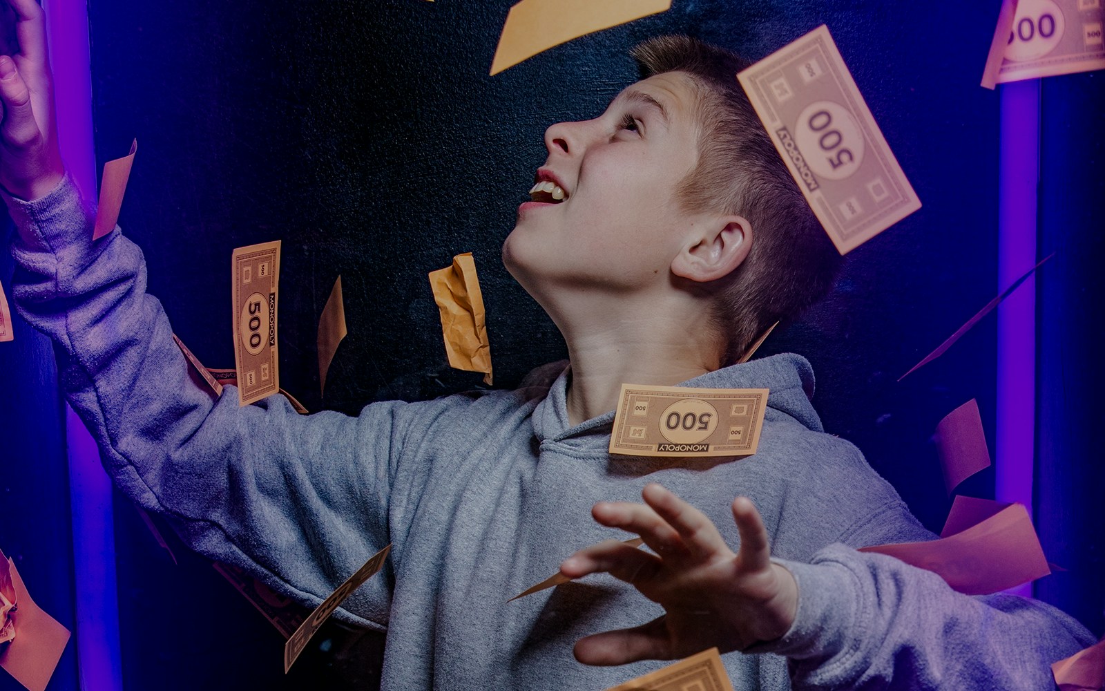 Guest catching Monopoly money at the Lifesized experience in London.