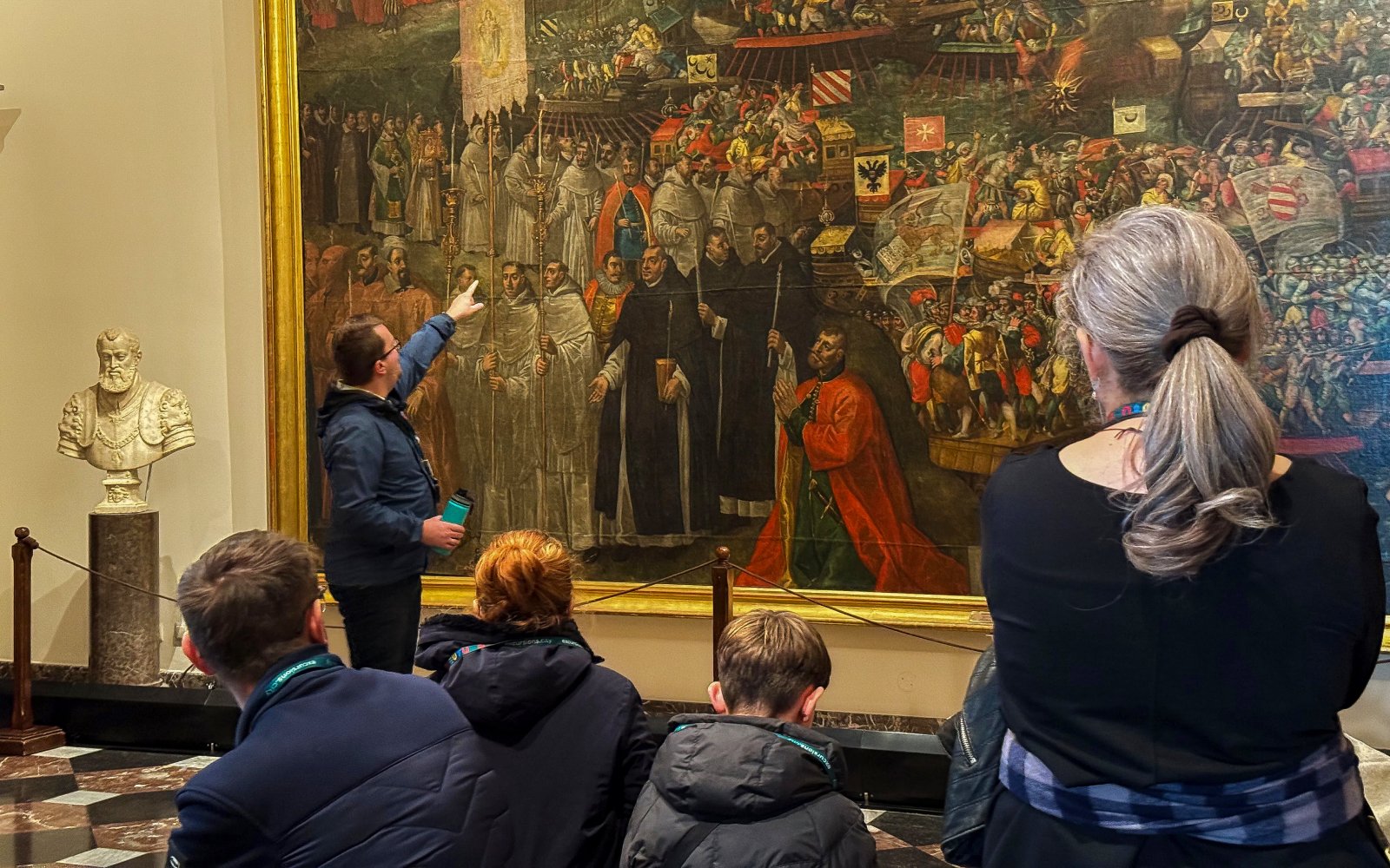 Tour guide explaining a large painting inside Wawel Cathedral, Krakow.