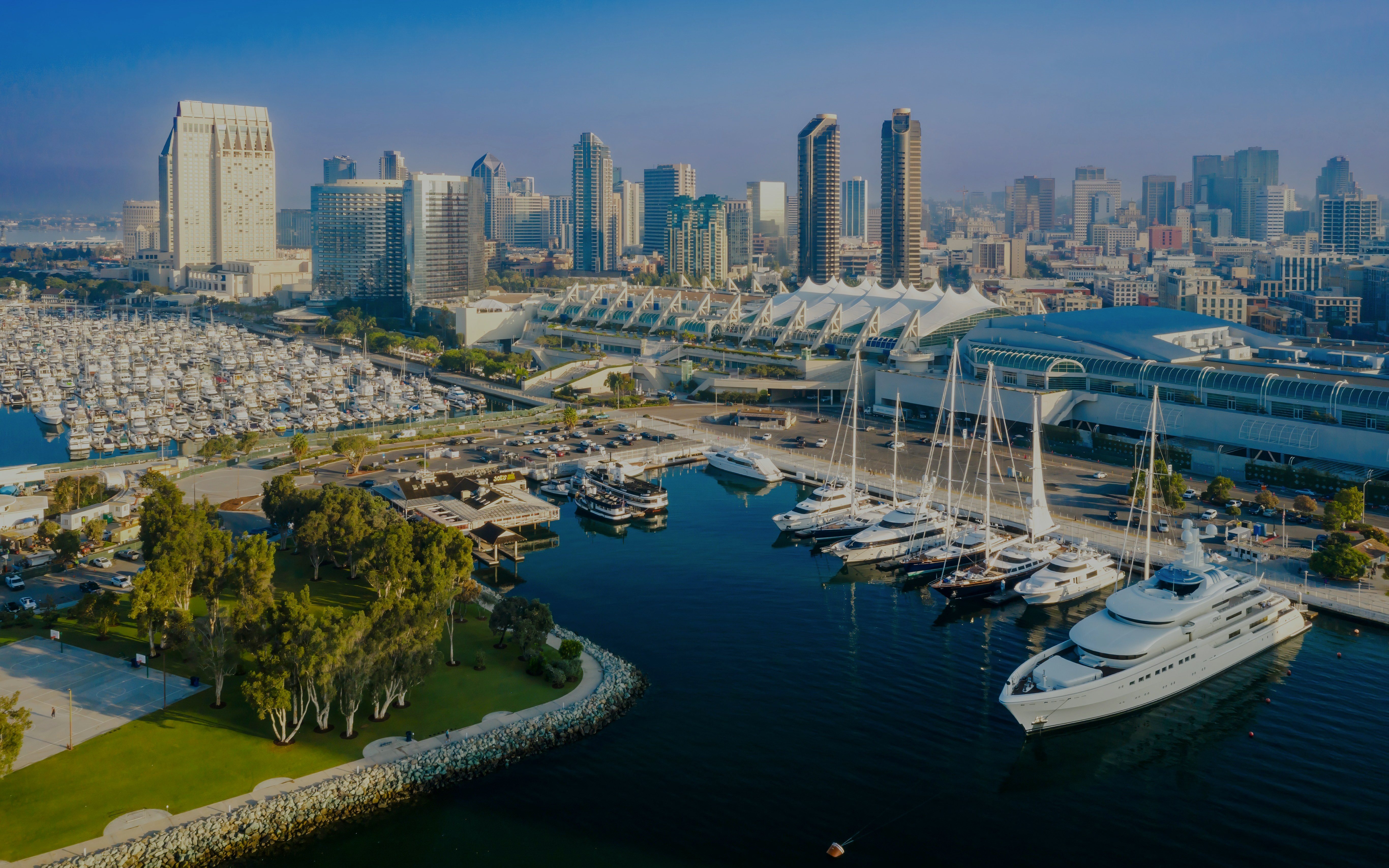 San Diego Convention Center with marina and city skyline in the background.