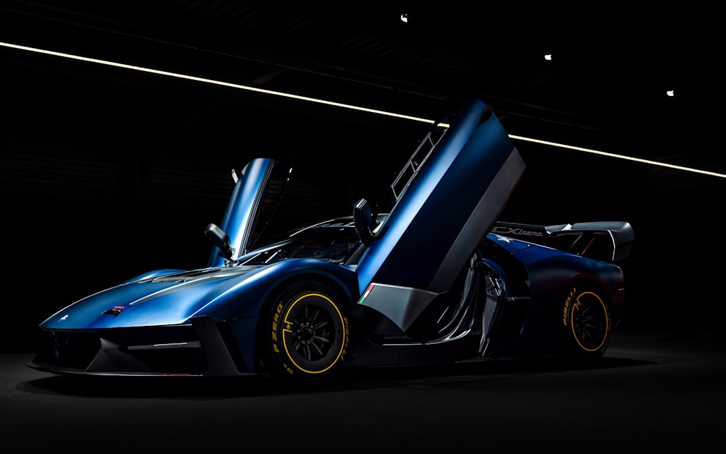 Sleek blue sports car with open doors at Coligny Car Museum, Lyon, France.