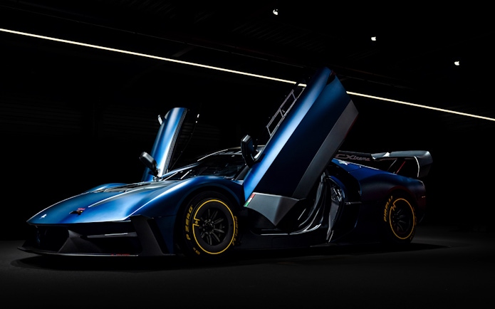 Sleek blue sports car with open doors at Coligny Car Museum, Lyon, France.