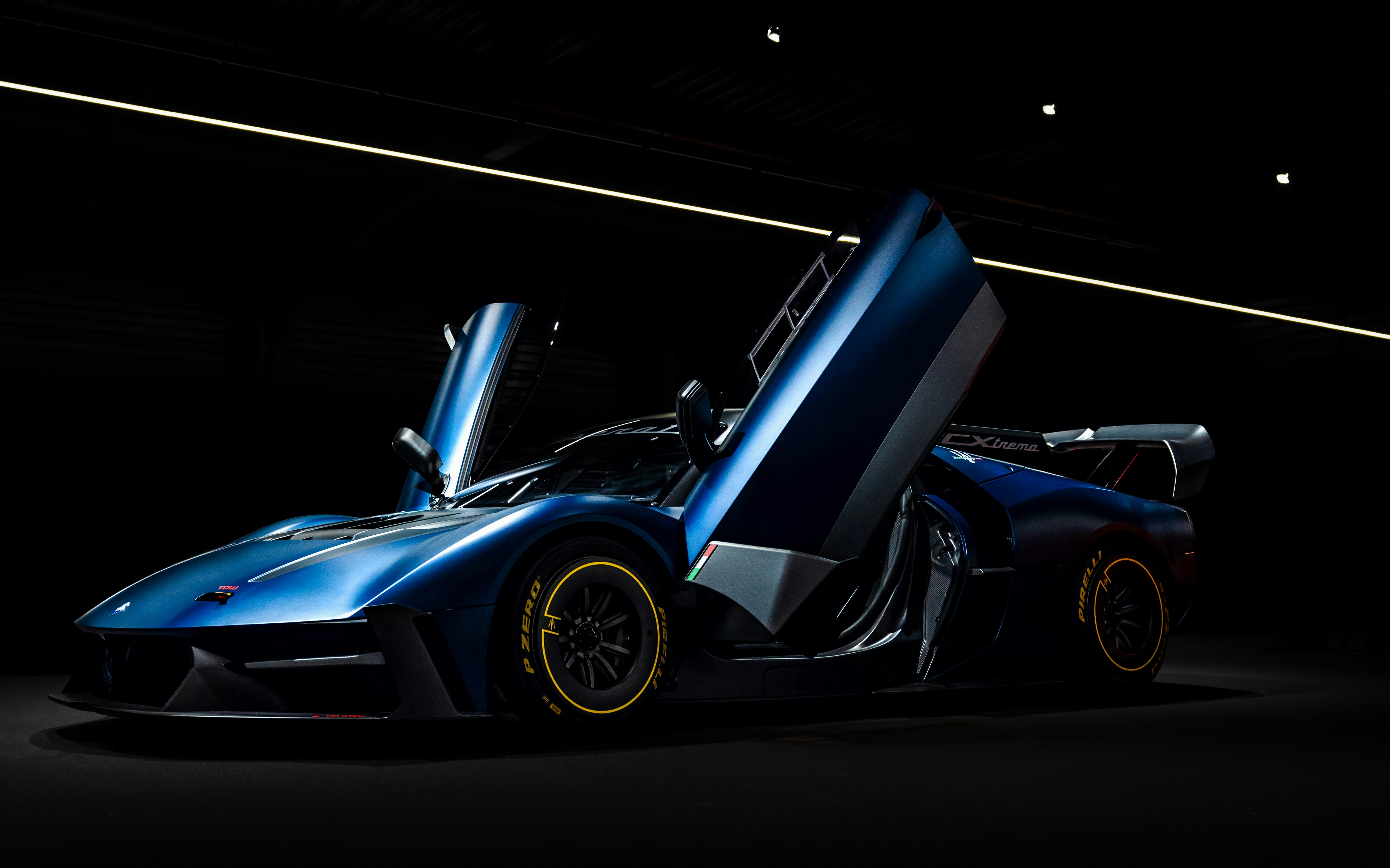 Sleek blue sports car with open doors at Coligny Car Museum, Lyon, France.