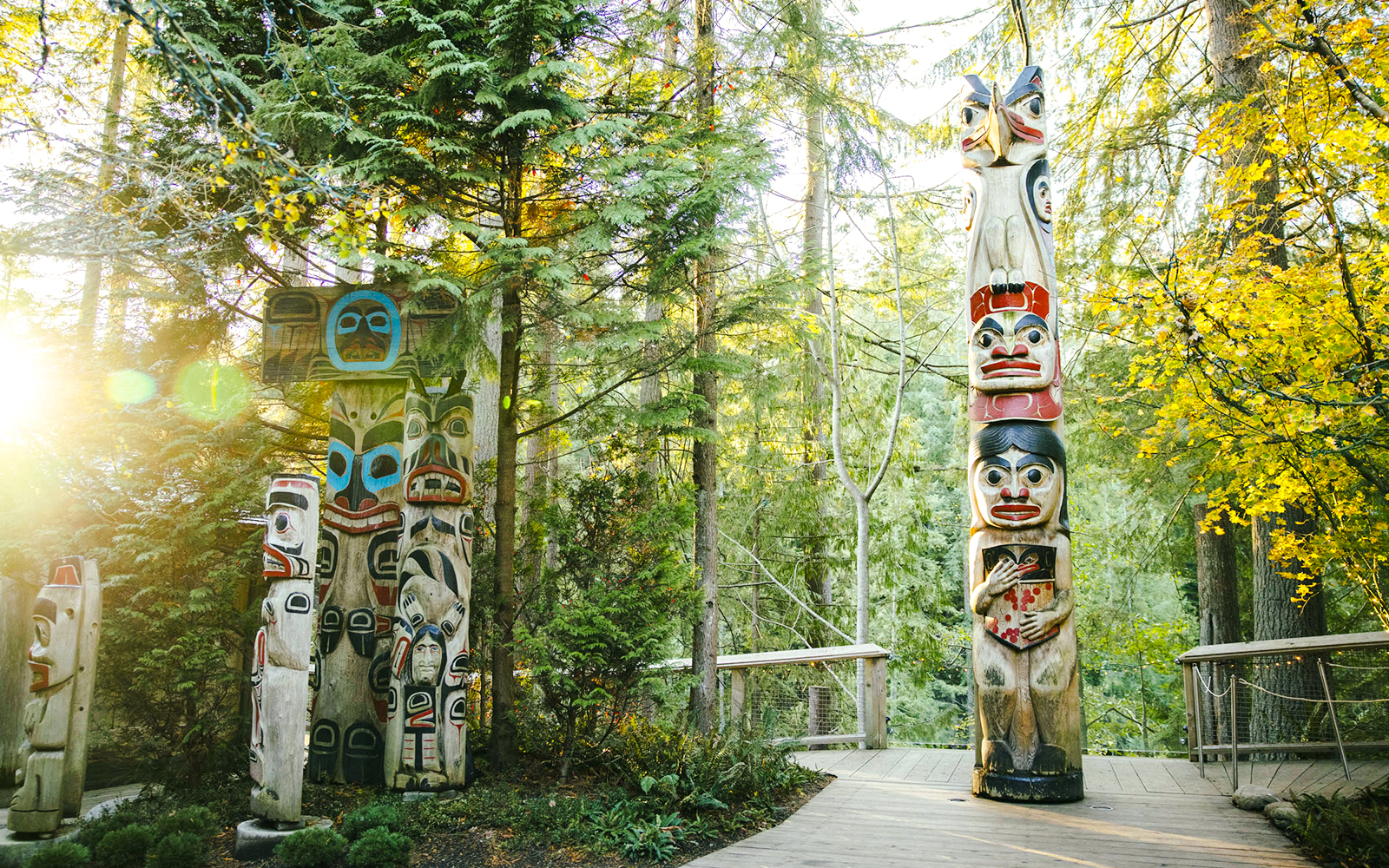 Totem poles surrounded by forest at Capilano Suspension Bridge Park.
