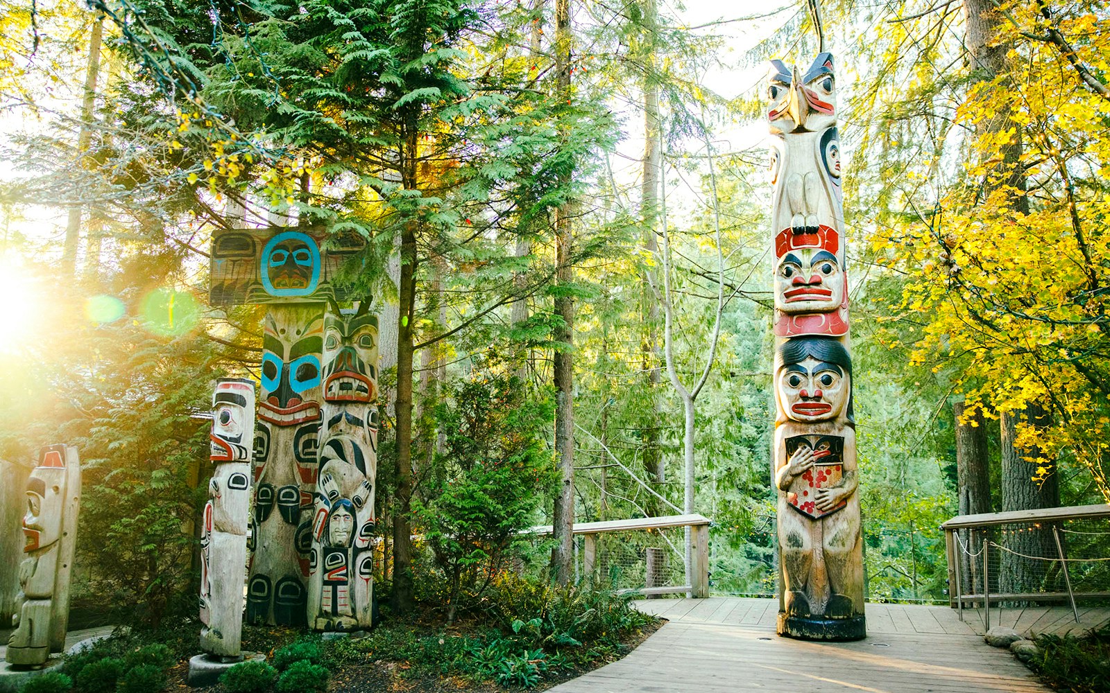 Totem poles surrounded by forest at Capilano Suspension Bridge Park.