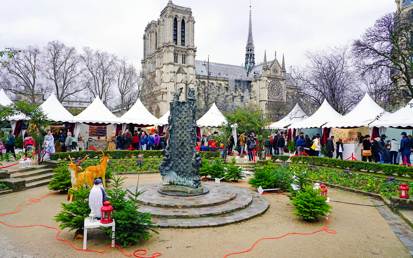 Paris Christmas Market with festive stalls near Notre-Dame Cathedral.