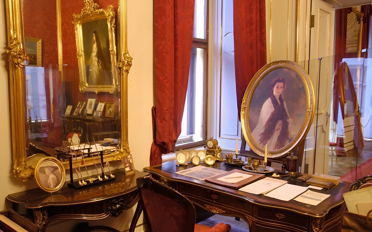 Vienna Sisi Museum interior with portraits and ornate furnishings.
