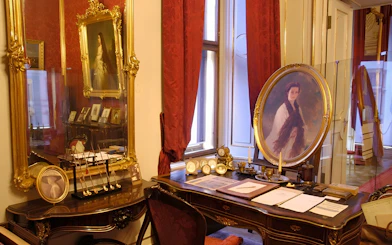 Vienna Sisi Museum interior with portraits and ornate furnishings.