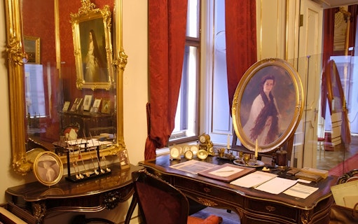 Vienna Sisi Museum interior with portraits and ornate furnishings.