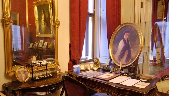 Vienna Sisi Museum interior with portraits and ornate furnishings.