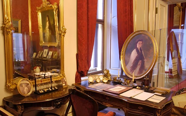Vienna Sisi Museum interior with portraits and ornate furnishings.