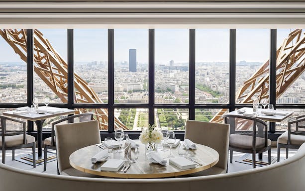 Dining area with Eiffel Tower view, Paris, for exclusive breakfast experience.