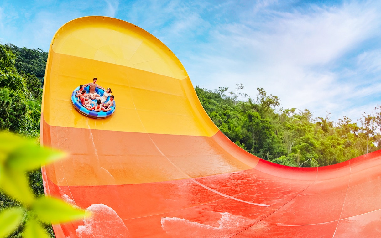 People enjoying a large waterslide at Water World Ocean Park, Hong Kong.