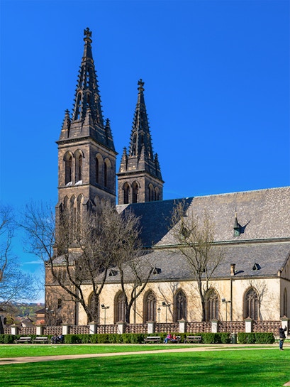 Vyšehrad Castle's twin spires and historic church in Prague, Czech Republic.