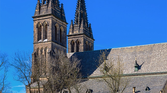 Vyšehrad Castle's twin spires and historic church in Prague, Czech Republic.