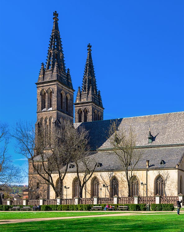 Vyšehrad Castle's twin spires and historic church in Prague, Czech Republic.