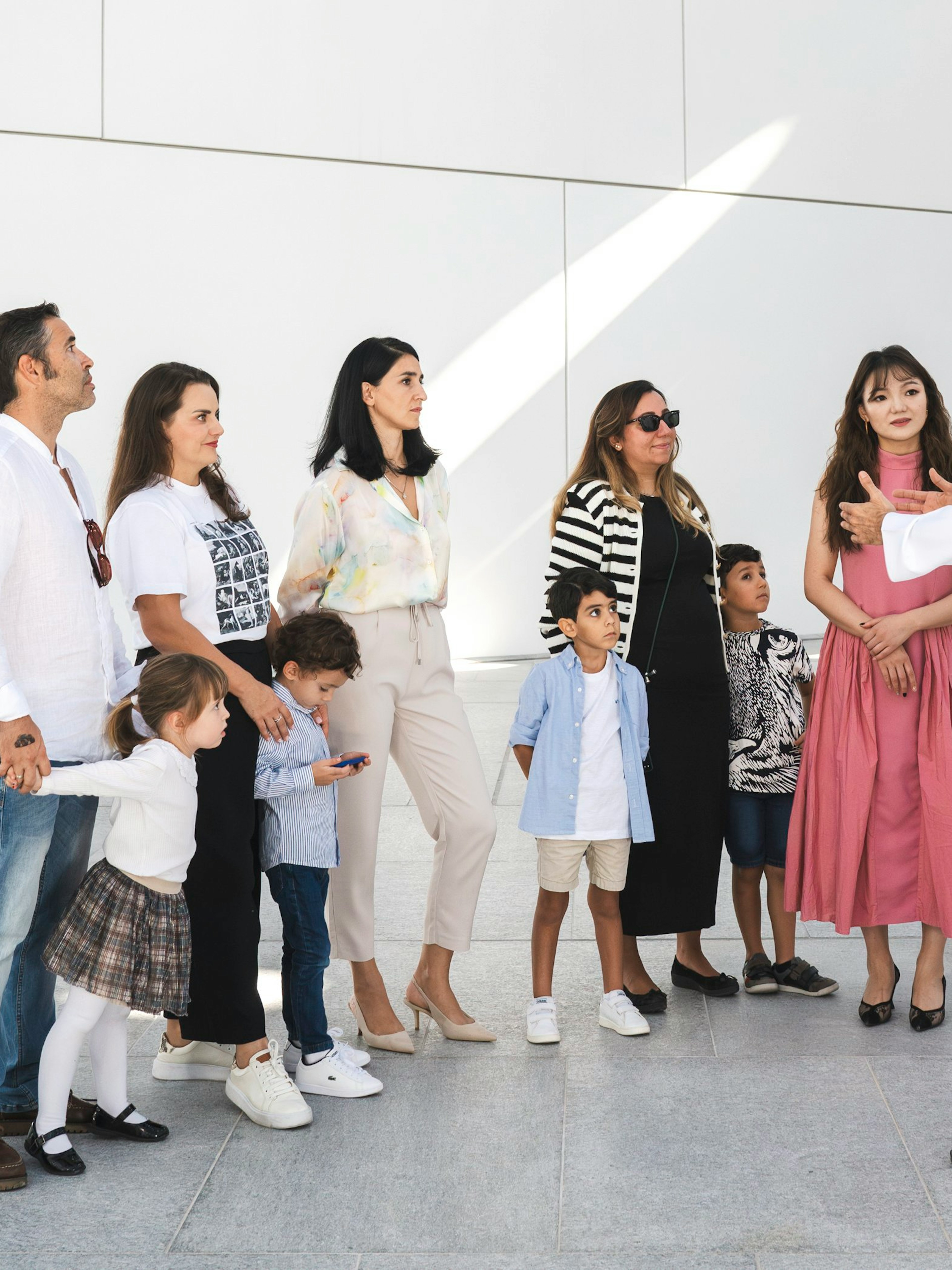 Family with guide at Louvre Abu Dhabi courtyard.